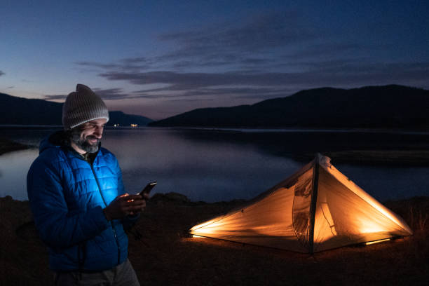 istock People and nature. Man camping at lakeshore. 1628283693