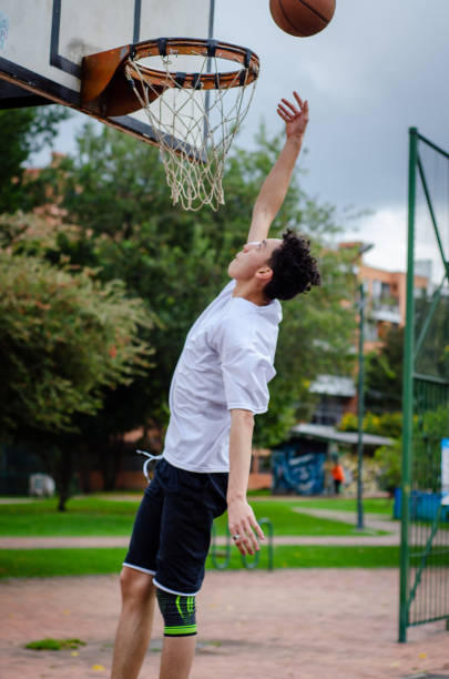 istock man playing basketball in urban park 1628286228