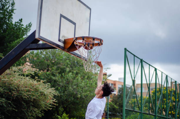 istock man playing basketball in urban park 1628286246