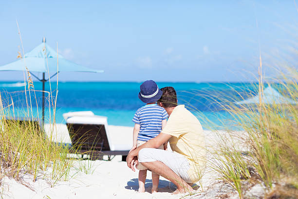 family at the beach relaxed father and son at the tropical beach grace bay stock pictures, royalty-free photos & images