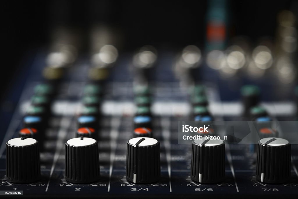 Music mixer desk Detail of a music mixer desk with various knobs Close-up Stock Photo