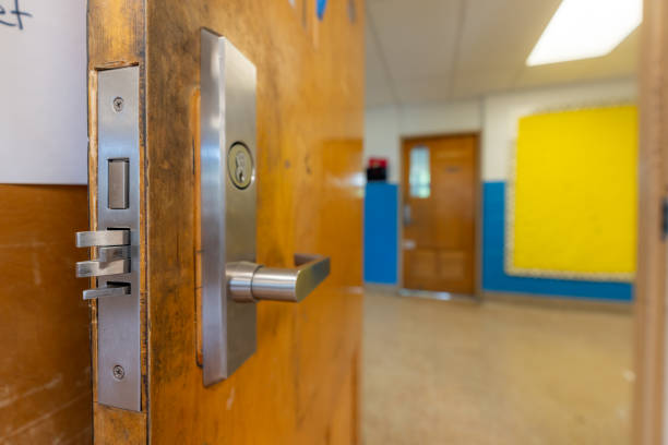 istock Open classroom door with new door hardware with security locks for a lockdown. 1628325894