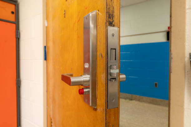 istock Open classroom door with new door hardware with security locks for a lockdown. 1628328004