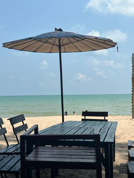 istock sea, umbrella, table, sand, hot weather 1628329050