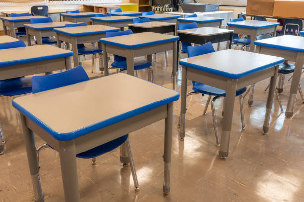 istock Example of an empty nondescript US High School Classroom with desks. 1628329055