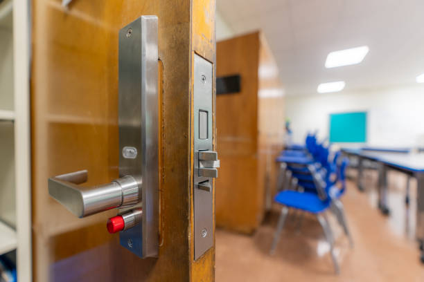 istock Open classroom door with new door hardware with security locks for a lockdown. 1628330589