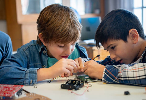 istock Curious boys working together in a robotics class at school 1628347144
