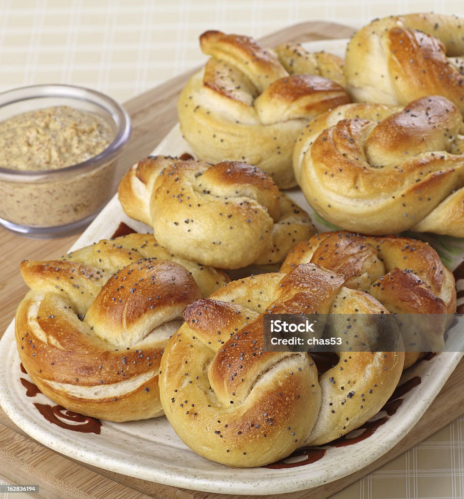 Soft Pretzels Soft pretzels on a platter with mustard dip Baked Stock Photo