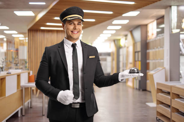 istock Bellboy holding a reception bell at a hotel 1628372079