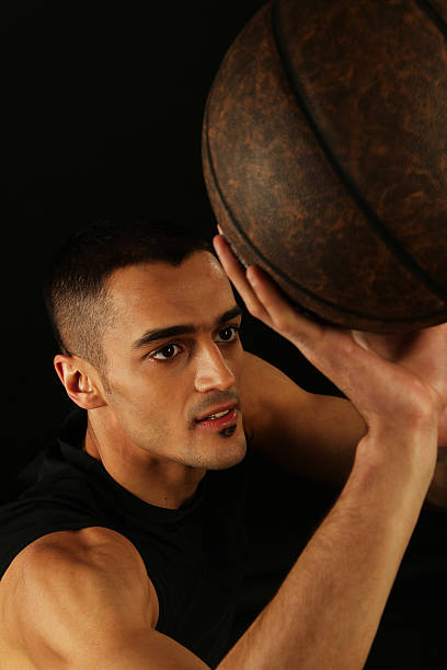 istock Basketball player holding ball 162842622