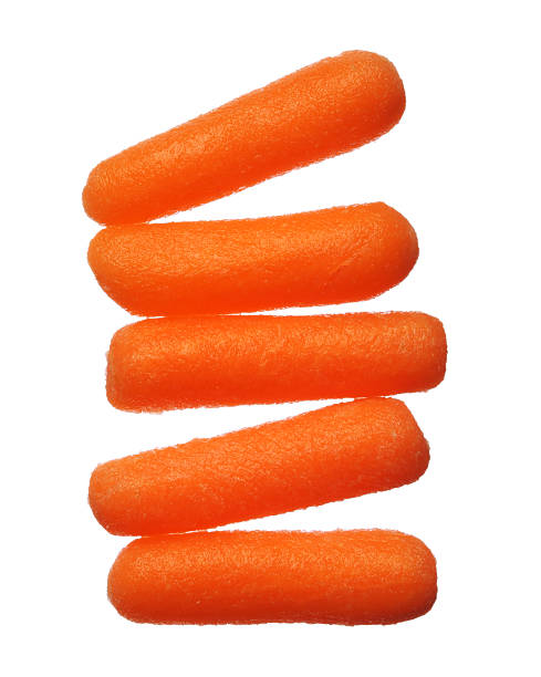 Five baby carrots isolated on white background