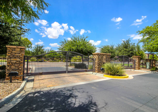 istock Two Metal Security Gates At Housing Subdivision 1628434804
