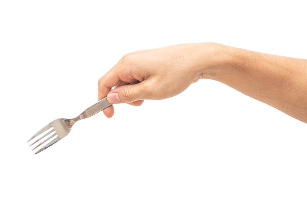 istock isolated of a man's hand holding a silver steel fork. 1628446327