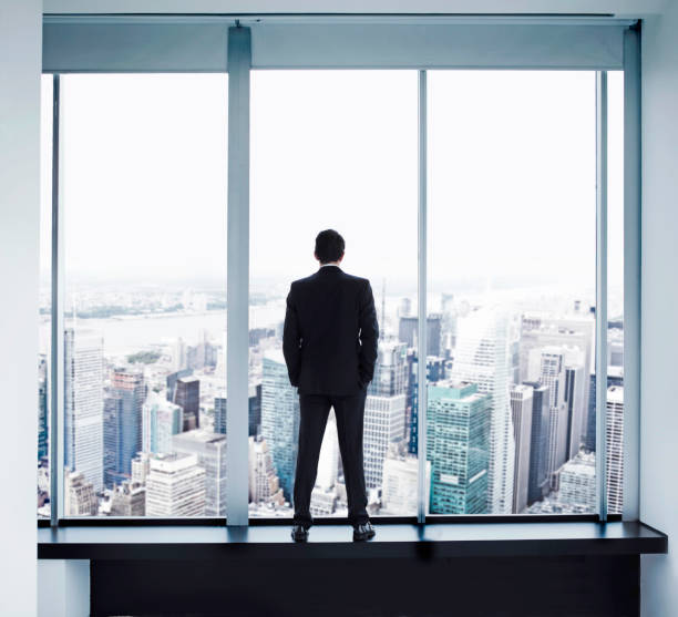 istock Young man looking out at Manhattan skyline 162846950