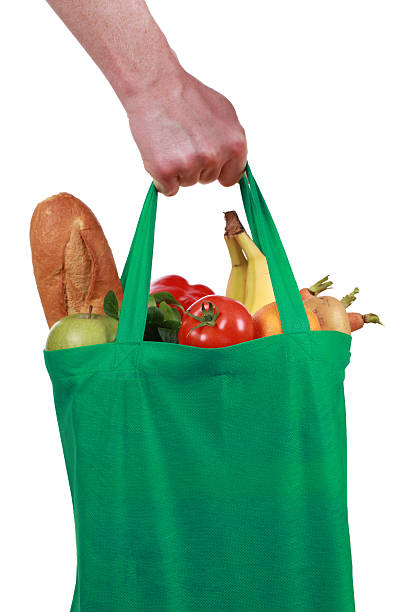 istock Hand holding a bag with groceries 162847541