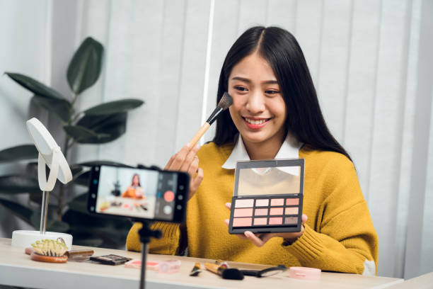 istock Young Asian beauty blogger is showcasing cosmetic products as well as tutorials on how to apply and record makeup tutorials on social media networks. 1628483789
