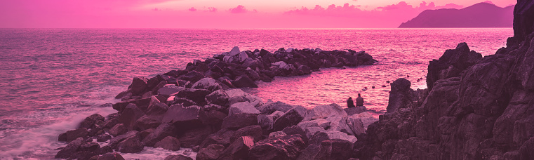 Seascape Rocky beach. Sunset over rocky coast. Cinque Terre Italy Horizontal banner