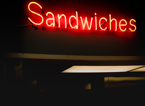 Deli neon lights that spell sandwiches for food restaurants