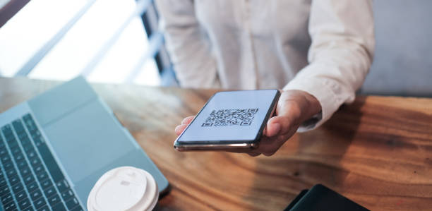 istock Qr code payment. Woman scanning QR code online shopping cashless technology concept. 1628613494