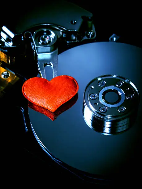 Red Heart Shape on the Opened Hard Disk Drive closeup