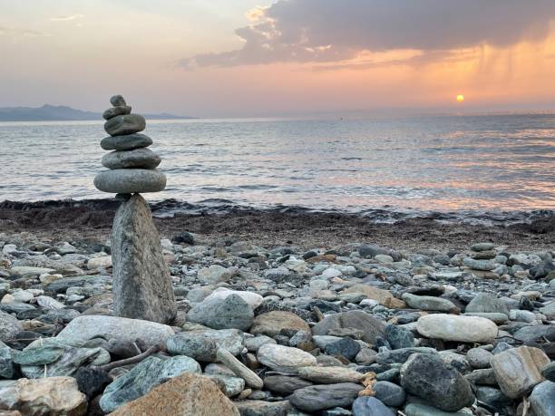 istock Cairns on the beach at sunset 1628665877