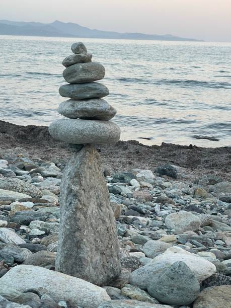 istock Cairns on the beach at sunset 1628666082