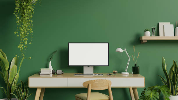 istock Modern green home office workspace with a computer on a desk, indoor tropical plants, a chair 1628684456