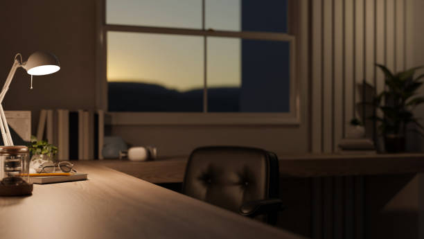 istock Copy space on a wooden table with a table lamp in a modern room in the evening. 1628684987