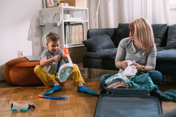istock mother and son packing bags for vacation 1628708075