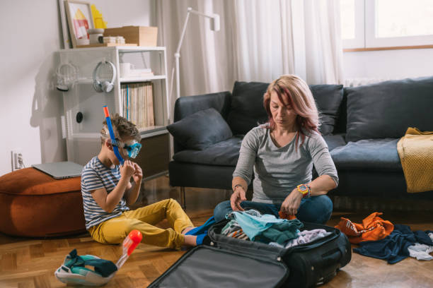 istock mother and son packing bags for vacation 1628708078