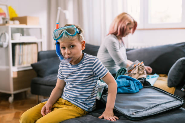 istock mother and son packing bags for vacation 1628708079
