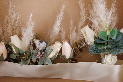 Close-up shot of elegant floral arrangements in boho style with fresh and dried flowers indoors
