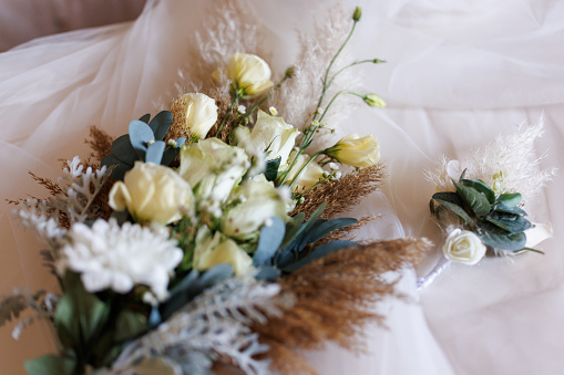 Close-up shot of elegant floral arrangements in boho style with fresh and dried flowers indoors