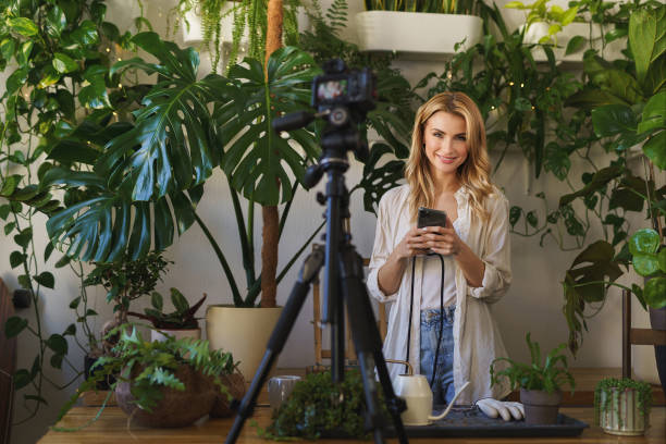 istock Florist blogger capturing her plant care routine in room with vibrant greenery 1628717521