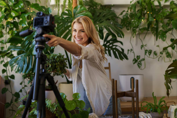 istock Florist blogger capturing her plant care routine in room with vibrant greenery 1628718937