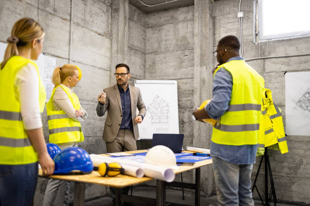 istock Team of structural engineers and architects having a meeting at construction site analyzing structure plant or blueprint. 1628726767