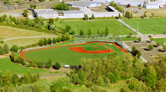 Oregon, USA - November 18, 2022: Aerial view of baseball and football pitch during sunny day.\n\nBaseball is a sport game, played between two teams of nine players each, taking turns batting and fielding.\n\nFootball is a team sports that involve, to varying degrees, kicking a ball to score a goal.
