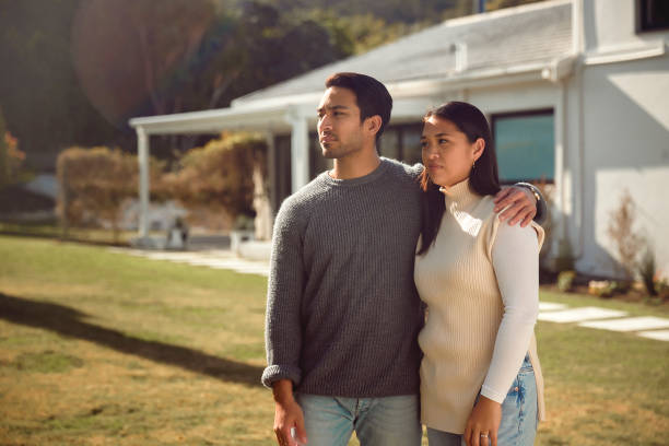 istock A Serious Couple Standing by Their Home 1628763878