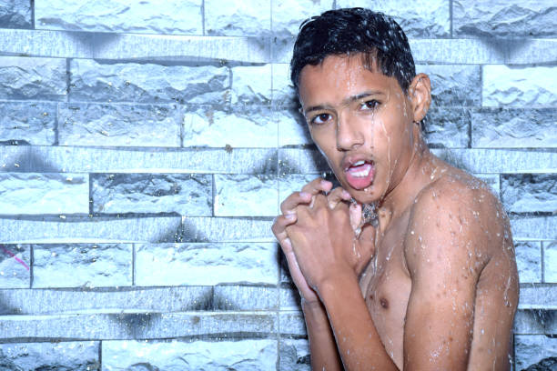 Above shot of a boy having fun diving in a bathtub full with clean water