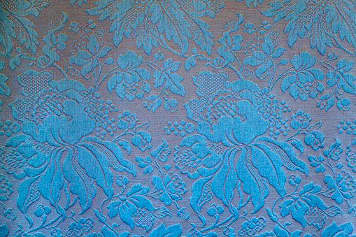 Fragment of an embroidered ornament of vintage wallpaper.