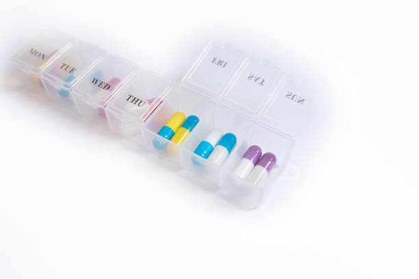 istock Daily pill box with medical pills on white background. Top view. Flat lay 1628809855