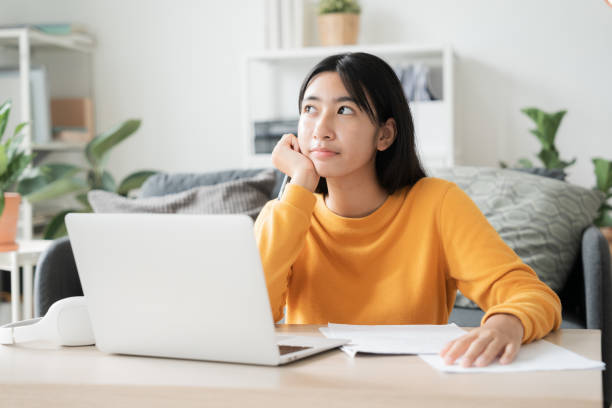Asian girl online learn video conference via internet with tutor on computer stock photo