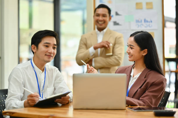 istock Business team looking at laptop screen, brainstorming for important project in modern corporate office 1628827938