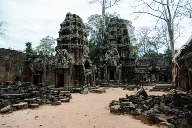 Ta Phrom, originally called Rajavihara, was founded by the Khmer King Jayavarman VII as a Mahayana Buddhist monastery and university. Unlike most Angkorian temples, Ta Prohm has been left in much the same condition in which it was found: the photogenic and atmospheric combination of trees growing out of the ruins and the jungle surroundings have made it one of Angkor's most popular temples with visitors.