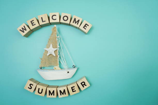 istock Welcome Summer message alphabet letter with sailboat on blue background 1628847705