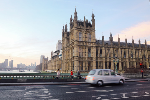 London, UK - 12 19 2017: Morning traffic cars and commuters are walking in London city center.