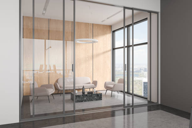 istock Relaxing zone in office interior with sofa and armchairs, panoramic window 1628874917