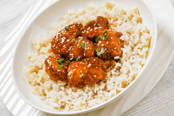 istock Baked Honey Sesame Chicken with brown rice 1628880098