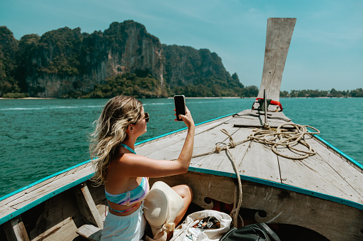 Young Caucasian woman in Thai Taxi boat in Krabi, Thailand