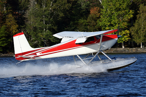 Cessna 180 Skywagon Floatplane, taking off from Moosehead Lake, Greenville, ME, USA - 11 September 2021